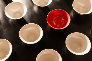 White and Red Bowls Placed On Black Wall for Decoration - Can be used as background