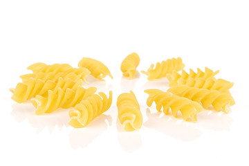 Lot of whole yellow pasta fusilli circle isolated on white background