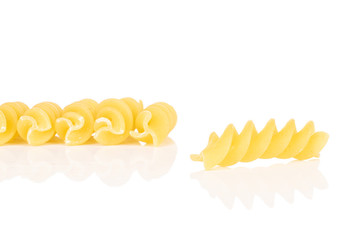 Group of six whole yellow pasta fusilli isolated on white background