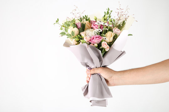 Female Hand Holding Beautiful Flower Bouquet On White Background