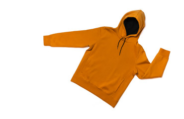 Yellow fashionable men's sweatshirt with a hood on white background top view. Fashionable male...