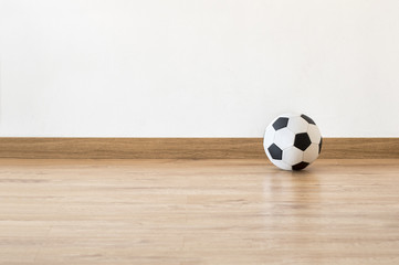 Soccer ball next to a white wall