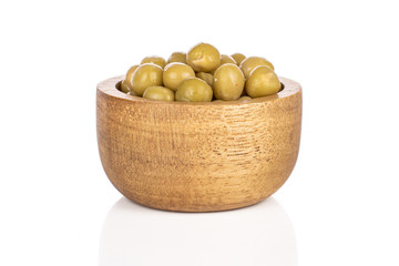 Lot of whole canned pea in bamboo bowl isolated on white background