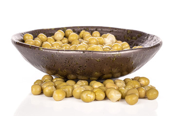 Lot of whole sweet canned pea in glazed bowl isolated on white background