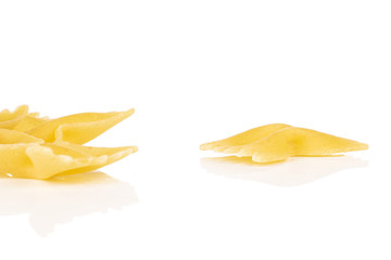 Group of three whole yellow pasta farfalle isolated on white background