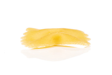 Fototapeta na wymiar One whole yellow pasta farfalle isolated on white background