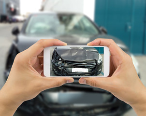 Man photographing his car with damages