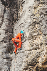 Woman climbs a rock. 