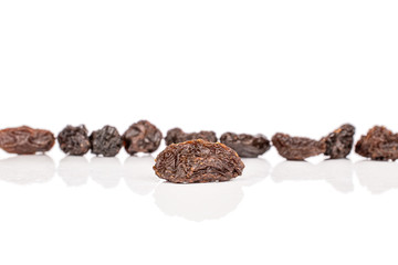 Lot of whole dried dark raisin one in front isolated on white background
