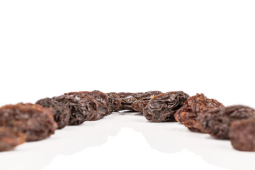 Lot of whole dried dark raisin isolated on white background
