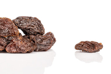 Lot of whole dried dark raisin isolated on white background