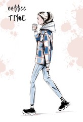 Hand drawn beautiful young woman in casual clothes. Fashion woman with coffee cup. Girl in sport shoes. Sketch. Fashion illustration.