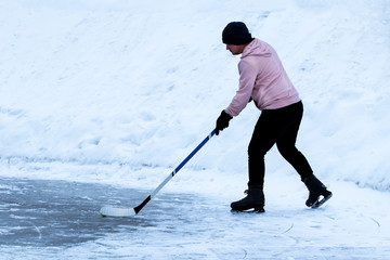  A young hockey player skates on ice