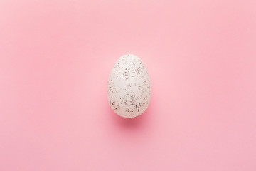 Painted egg on pink background. Easter holiday concept