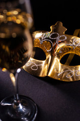 carnival mask and champagne on a black background