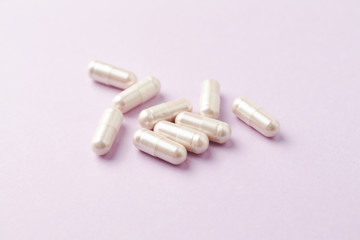 Carnitine capsules. Concept for a healthy dietary supplementation. Bright paper background. Soft...