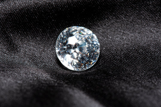 An artificial cubic zirconium gem on a black fabric