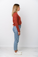 Full body young caucasian woman gazing left, sideways pose.