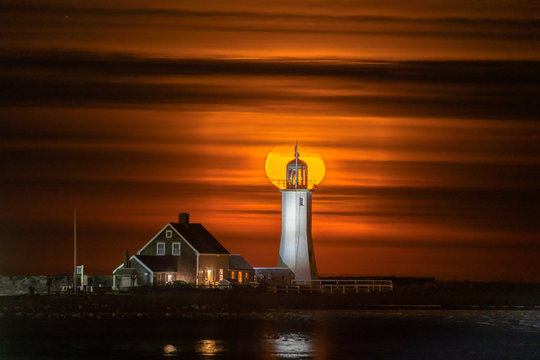 Full Moon Rises behind Scituate Lighthouse in Massachusetts