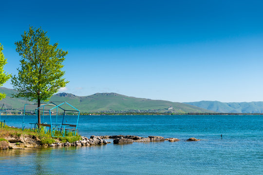 Calm beautiful lake Sevan with clear water in Armenia, a natural landmark at sunrise