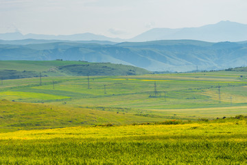Scenic view of green fields and meadows and mountains of Armenia, landscape in summer