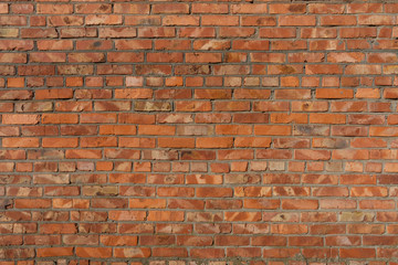 Old repaired weathered brick wall for background. 