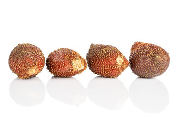 Group of four whole exotic brown salak isolated on white background