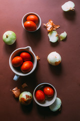 Dyeing eggs for Easter holidays, coloring with different color and tonality using natural food dye pigment and painting color, over a white  background, chocolate eggs , top view, flatlay,soft light