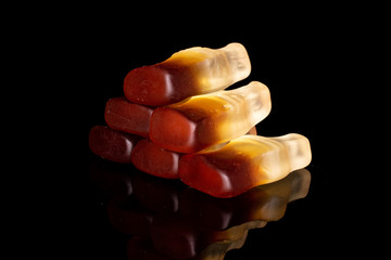 Group of six whole sweet jelly cola isolated on black glass