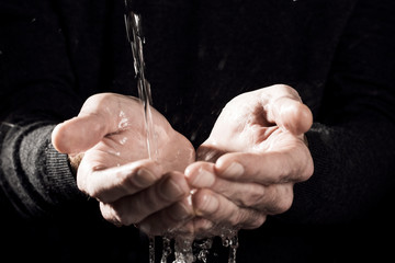 male hands catching water