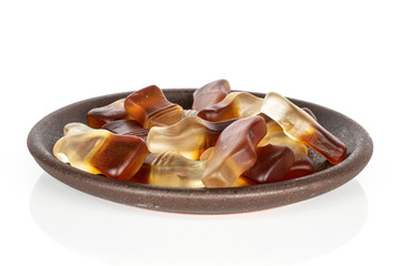 Lot of whole sweet jelly cola with brown ceramic coaster isolated on white background
