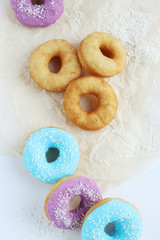 multicolored donuts in a basket with icing, top view, side view