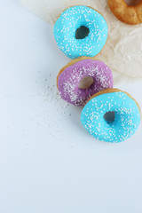 multicolored donuts in a basket with icing, top view, side view