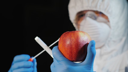 Side view of The scientist shoots a sample in the big apple. Food quality study