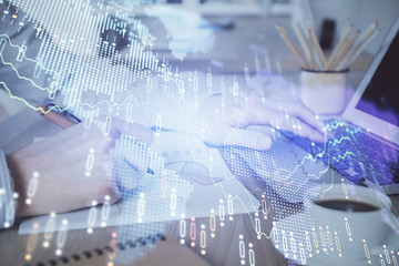 Multi exposure of stock market graph with man working on laptop on background. Concept of financial analysis.