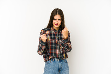 Young caucasian woman isolated on white background showing fist to camera, aggressive facial...