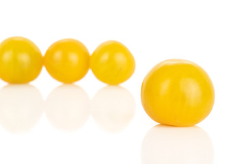 Group of four whole fresh yellow tomato isolated on white background