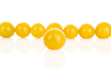Group of eight whole fresh yellow tomato isolated on white background