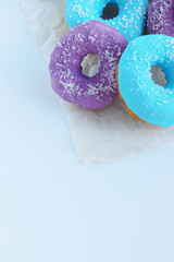 multicolored donuts in a basket with icing, top view, side view