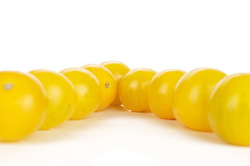 Lot of whole fresh yellow tomato delta isolated on white background