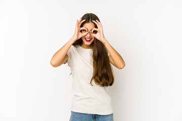 Young caucasian woman isolated on white background excited keeping ok gesture on eye.