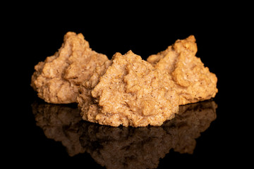 Group of three whole homemade brown coconut biscuit with chocolate isolated on black glass