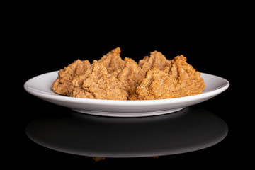 Group of seven whole homemade brown coconut biscuit with chocolate on white ceramic plate isolated on black glass