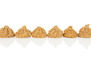 Group of six whole homemade brown coconut biscuit with chocolate line isolated on white background