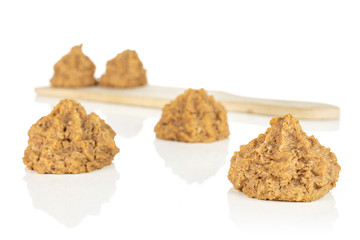 Group of five whole homemade brown coconut biscuit with chocolate on small wooden cutting board isolated on white background