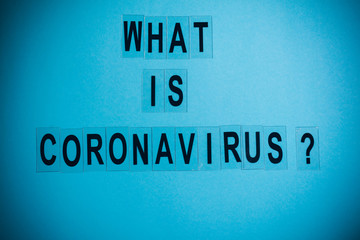 what is coronavirus word written on blue background. what is coronavirus text on wooden table for your desing, coronavirus concept top view.