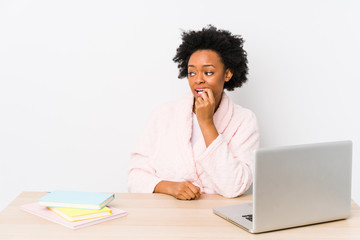 Middle aged african american woman working at home isolated relaxed thinking about something looking at a copy space.