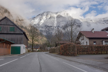 Road with beautiful mountain view and the small village of Oblarn in the district of Liezen in Styria, Austria.