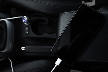 Mobile phone, smartphone charge battery, charging in the car plug close up