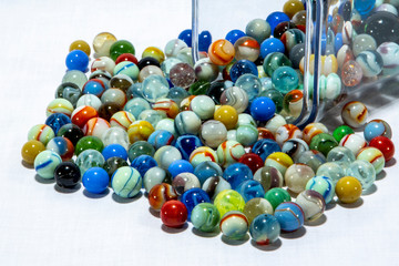 Marbles spill from container 222